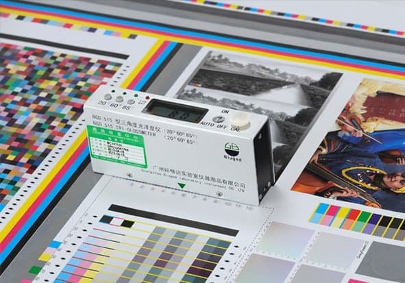 Tri-gloss Meter checking surface gloss level and print finish quality of paper packaging