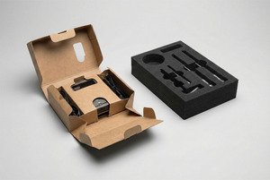 Side-by-side comparison of a sustainable folded paperboard insert and a traditional foam insert.