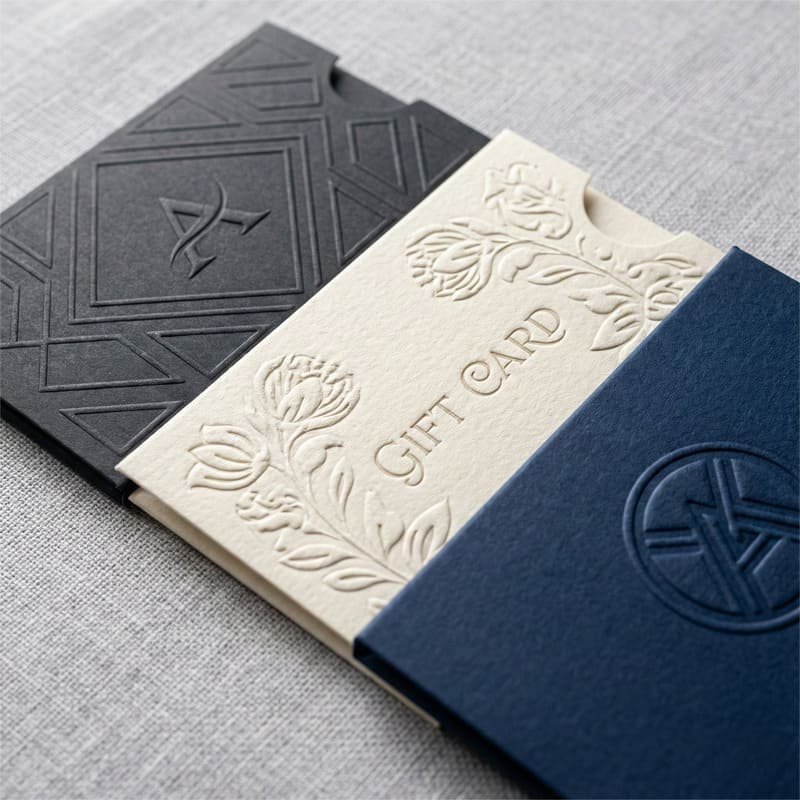 Gift card holders with embossed logos and designs, offering a tactile experience for premium branding.