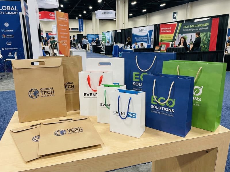 Custom paper bags for trade shows and events in various sizes and printed branding styles.